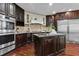 Gourmet kitchen featuring stainless steel appliances, dark wood cabinetry, and granite countertops at 2990 Hearthstone Dr, Cumming, GA 30041