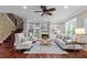 Bright living room with hardwood floors, built-in bookshelves, fireplace, and ample seating at 2990 Hearthstone Dr, Cumming, GA 30041