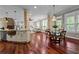 Open floor plan showcases hardwood floors, brick pillars, a dining area, and a spacious living room at 2990 Hearthstone Dr, Cumming, GA 30041