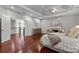 Bright main bedroom showcasing trey ceiling, hardwood floors, fireplace, sitting area, and entry to hallway at 2990 Hearthstone Dr, Cumming, GA 30041