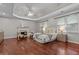 This main bedroom features hardwood floors, a fireplace, and a decorative tray ceiling at 2990 Hearthstone Dr, Cumming, GA 30041