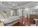 Bright main bedroom featuring trey ceiling, hardwood floors, sitting area, and entry to hallway at 2990 Hearthstone Dr, Cumming, GA 30041