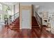 Open floor plan with hardwood floors, grand staircase, and easy access to living spaces at 2990 Hearthstone Dr, Cumming, GA 30041