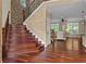 Staircase features hardwood steps, custom railing, and brick wall accent in this beautiful home at 2990 Hearthstone Dr, Cumming, GA 30041