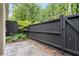 Backyard featuring a black privacy fence, stone patio, and lush greenery at 3663 Essex Ave # 29, Atlanta, GA 30339