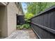 Backyard featuring a black privacy fence, stone patio, and lush greenery at 3663 Essex Ave # 29, Atlanta, GA 30339