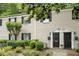 Charming two-story townhome featuring black shutters, well maintained lawn, and a landscaped front yard at 3663 Essex Ave # 29, Atlanta, GA 30339