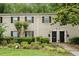 Charming two-story townhome featuring black shutters, well maintained lawn, and a landscaped front yard at 3663 Essex Ave # 29, Atlanta, GA 30339