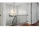 Upstairs hallway with wood flooring, black railing, and gray walls at 3663 Essex Ave # 29, Atlanta, GA 30339
