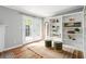 Bright living room with a fireplace, French doors to backyard, built-in bookshelves, and hardwood flooring at 3663 Essex Ave # 29, Atlanta, GA 30339
