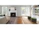 Inviting living room featuring a fireplace, French doors to the backyard, and hardwood flooring at 3663 Essex Ave # 29, Atlanta, GA 30339