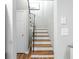 View of hardwood staircase with white risers and a black metal railing at 3663 Essex Ave # 29, Atlanta, GA 30339