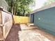 Fenced backyard with brick home, wooden fence, and concrete patio at 75 Mayson Ne Ave, Atlanta, GA 30307