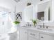 Modern bathroom with double sink vanity, illuminated mirrors, and sleek, glass-enclosed marble shower at 75 Mayson Ne Ave, Atlanta, GA 30307
