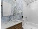 Charming bathroom with patterned wallpaper, a wood vanity, a shower-tub combination, and ample lighting at 75 Mayson Ne Ave, Atlanta, GA 30307