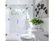 Contemporary bathroom features marble shower with dual shower heads and natural light from small window at 75 Mayson Ne Ave, Atlanta, GA 30307