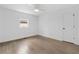 Spacious bedroom with wood floors, white walls, one window, and one door at 75 Mayson Ne Ave, Atlanta, GA 30307
