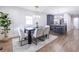 Open-concept dining area showcases a modern table, stylish chairs, and seamless flow into the adjacent kitchen at 75 Mayson Ne Ave, Atlanta, GA 30307