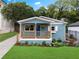 Beautifully renovated bungalow showcasing a quaint porch, blue facade, and professionally landscaped garden at 75 Mayson Ne Ave, Atlanta, GA 30307