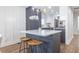 Modern kitchen island featuring white countertop, trendy pendant lighting, and stylish counter stools at 75 Mayson Ne Ave, Atlanta, GA 30307