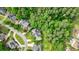 An aerial view showcasing the home's location, nestled in a mature neighborhood with lush trees at 10830 Carrara Cv, Alpharetta, GA 30022