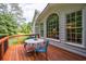 Outdoor deck with table and chairs, offering a cozy space with views of the backyard and natural light at 10830 Carrara Cv, Alpharetta, GA 30022