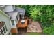 A rear view of the back deck with table, chairs and stone patio, perfect for outdoor relaxation and entertaining at 10830 Carrara Cv, Alpharetta, GA 30022