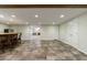 Finished basement showcasing tile flooring, a stylish bar, and an open layout at 10830 Carrara Cv, Alpharetta, GA 30022