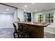 Finished basement bar area with a built-in bar and stylish decor and natural light at 10830 Carrara Cv, Alpharetta, GA 30022