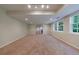 Large finished basement with neutral carpet, recessed lighting, and bright windows at 10830 Carrara Cv, Alpharetta, GA 30022