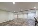 Finished basement showcasing tile flooring, recessed lighting, and an open layout at 10830 Carrara Cv, Alpharetta, GA 30022