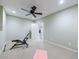 Basement area provides versatile space, an exercise machine, ceiling fan and neutral tones at 10830 Carrara Cv, Alpharetta, GA 30022