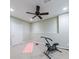 Basement offers a versatile space and exercise equipment, with a ceiling fan at 10830 Carrara Cv, Alpharetta, GA 30022