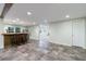 Spacious basement area featuring a bar with seating and stylish tile flooring at 10830 Carrara Cv, Alpharetta, GA 30022