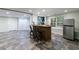 Finished basement with a bar area, recessed lighting, and stylish tile flooring at 10830 Carrara Cv, Alpharetta, GA 30022
