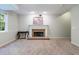 Spacious finished basement featuring a cozy brick fireplace and neutral carpet at 10830 Carrara Cv, Alpharetta, GA 30022