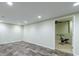 Finished basement space with exercise equipment, recessed lighting and neutral walls at 10830 Carrara Cv, Alpharetta, GA 30022
