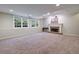 Finished basement featuring natural light, neutral carpet, and a charming fireplace at 10830 Carrara Cv, Alpharetta, GA 30022