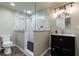 Modern bathroom with a tiled shower, glass door and sleek vanity at 10830 Carrara Cv, Alpharetta, GA 30022
