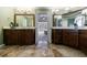 Bathroom with and vanities, travertine floors, and view into main bedroom at 10830 Carrara Cv, Alpharetta, GA 30022