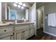 Bathroom vanity featuring a granite countertop, decorative hardware, and an open doorway at 10830 Carrara Cv, Alpharetta, GA 30022