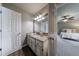 Bathroom vanity featuring a granite countertop and an open doorway to main bedroom at 10830 Carrara Cv, Alpharetta, GA 30022
