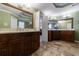 Bathroom with and vanities, travertine floors, and modern fixtures at 10830 Carrara Cv, Alpharetta, GA 30022