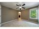 Neutral bedroom featuring a ceiling fan and a window offering natural light at 10830 Carrara Cv, Alpharetta, GA 30022