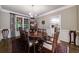Spacious dining room with hardwood floors, large table, and chandelier lighting at 10830 Carrara Cv, Alpharetta, GA 30022