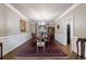 Formal dining room with hardwood floors, chandelier, and large windows for natural light at 10830 Carrara Cv, Alpharetta, GA 30022