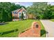 Beautiful brick home with an expansive green lawn, mature trees, and a charming brick mailbox at 10830 Carrara Cv, Alpharetta, GA 30022