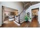 Elegant foyer featuring hardwood floors, staircase with iron railings, and view to the living room at 10830 Carrara Cv, Alpharetta, GA 30022