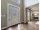 Inviting foyer with decorative glass front door and sidelights, plus hardwood floors at 10830 Carrara Cv, Alpharetta, GA 30022