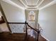 Grand foyer with a decorative chandelier, staircase, and a view of the front door and entryway at 10830 Carrara Cv, Alpharetta, GA 30022